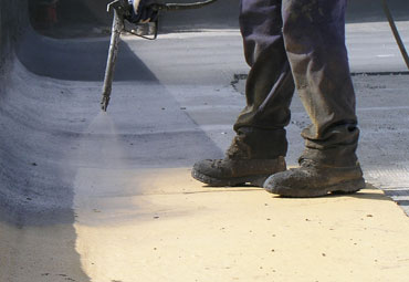 Coating systems over Charlotte spray foam roof systems